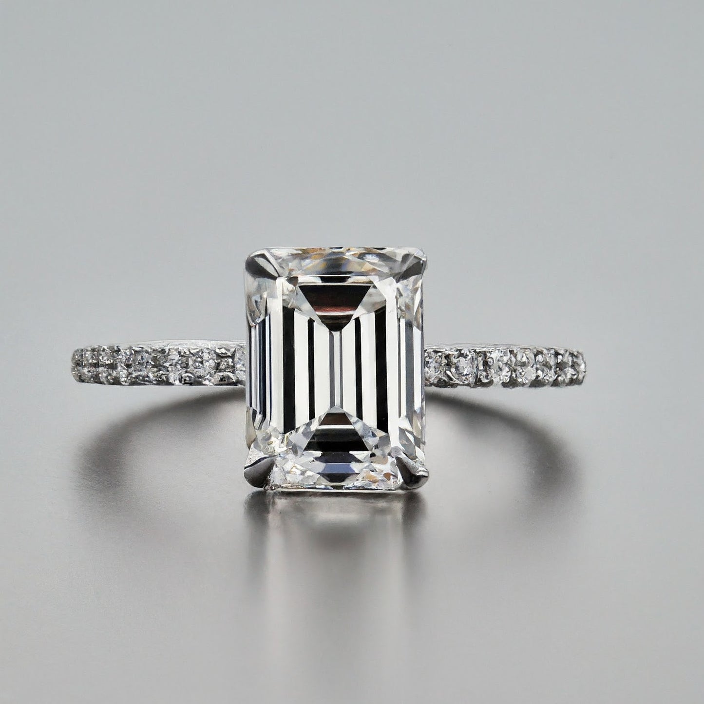 4 Prong Emerald Cut Side Stone Diamond Ring